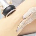 Cavitation rf body treatment. Female ultra sound lipo machine. Spa contouring. Doctor hands Royalty Free Stock Photo