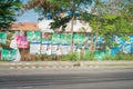 Cluttered political campaign posters from various political Filipino candidates posted on a fence of a subdivision village.