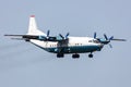 Cavok Air Antonov An-12 cargo plane at airport apron with marshaller. Air freight and shipping. Aviation and aircraft