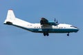 Cavok Air Antonov An-12 cargo plane at airport apron with marshaller. Air freight and shipping. Aviation and aircraft