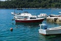 Cavtat / Croatia - 02 May 2019: Fishing village with small boats and an old man cleaning his fish of the day in the adriatic sea.