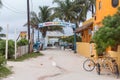 CAYE CAULKER, BELIZE - NOVEMBER 20, 2017: Caye Caulker Island in Caribbean Sea. Sandy Street with Local Architecture and Exit Sign