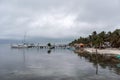 CAYE CAULKER, BELIZE - NOVEMBER 20, 2017: Caye Caulker Island in Caribbean Sea. Cloudy Morning And Calm Water in Pier.