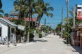 CAYE CAULKER, BELIZE - NOVEMBER 18, 2017: Caye Caulker Island in Caribbean Sea. Sandy Street with Local Architecture and People.