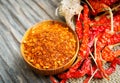 Cayenne pepper in wood bowl and dried red chili with sack on old wooden table background Royalty Free Stock Photo