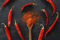 cayenne pepper on wooden spoon spices and dried chilli peppers background Royalty Free Stock Photo