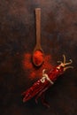 cayenne pepper on wooden spoon spices and dried chilli peppers background Royalty Free Stock Photo