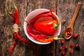 Cayenne red pepper in a white plate on a wooden table spoon Royalty Free Stock Photo