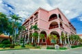 Gorgeous view of Colonial hotel grounds, beautiful inviting retro stylish main building on blue sky background