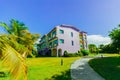 inviting view of hotel buildings standing in tropical garden on sunny beautiful day