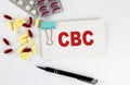 CBC text written in a card with pills. Medical concept