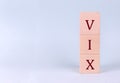 CBOE Volatility Index, or VIX, on wooden cubes on a blue background