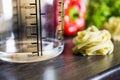 100ccm / 100ml Of Water In A Measuring Cup On A Kitchen Counter With Food Royalty Free Stock Photo