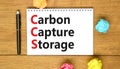 CCS Carbon capture storage symbol. Concept words CCS Carbon capture storage on beautiful white note. Beautiful wooden table