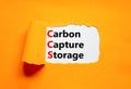 CCS Carbon capture storage symbol. Concept words CCS Carbon capture storage on beautiful white paper. Beautiful orange paper