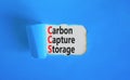 CCS Carbon capture storage symbol. Concept words CCS Carbon capture storage on beautiful white paper. Beautiful blue paper