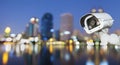 CCTV with bokeh blurring city in night background. Royalty Free Stock Photo