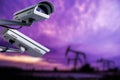 CCTV camera concept with silhouettes of oil well