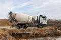 Concrete mixer truck loads concrete at the factory. Transportation of concrete to the construction site. Construction equipment fo Royalty Free Stock Photo