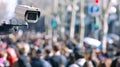 CCTV camera focused on a dense crowd on a street