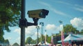 A CCTV camera mounted on a high pole surveys a festival venue keeping a watchful eye on any hostile vehicle activity.