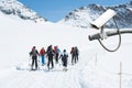 CCTV Camera Operating on snow mountain with people hiking in background