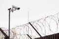 CCTV camera and the barbed wire fence Royalty Free Stock Photo