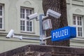 CCTV cameras on display next to a police station with a police sign in German: Polizei in the Bavarian city of Munich. Royalty Free Stock Photo