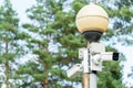 CCTV cameras in a protective white case on a lamppost. Outdoor video surveillance camera installed on the streets of the city for