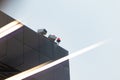 CCTV cameras on the roof of an office building on the street on a cloudy day against the background of a gray sky Royalty Free Stock Photo