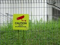 CCTV or Closed-circuit Television warning sign is hung on the fence as a warning to those who intend to trespass.