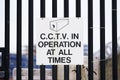 CCTV in operation at all times sign on black metal fence railing