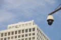 CCTV security camera with blue sky and white office building to monitor crimes and accidents 24 7 in the city center Royalty Free Stock Photo