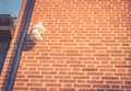 CCTV security camera in front of an office building in the city with copy space. Retro style Royalty Free Stock Photo