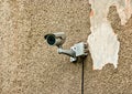 CCTV security camera mounted on the damaged wall outside