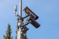 CCTV security camera and surveillance on a pole against the backdrop of blue sky Royalty Free Stock Photo