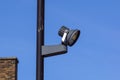 CCTV security camera and surveillance on a pole against the backdrop of blue sky Royalty Free Stock Photo