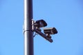 CCTV security camera and surveillance on a pole against the backdrop of blue sky Royalty Free Stock Photo