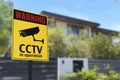 A CCTV sign in front of a gated home. Warning to visitors or burglars.