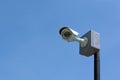 CCTV surveillance security camera on a black pole with blue sky background Royalty Free Stock Photo
