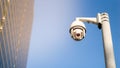 CCTV surveillance security camera on pole in city for safety system area control outdoor with flare light effect and copy space Royalty Free Stock Photo