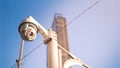 CCTV surveillance security camera on pole in city for safety system area control outdoor with flare light effect and copy space Royalty Free Stock Photo