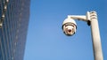 CCTV surveillance security camera on pole in city with tower building background for safety system area control outdoor and copy Royalty Free Stock Photo