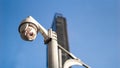 CCTV surveillance security camera on pole in city with tower building background for safety system area control outdoor and copy Royalty Free Stock Photo