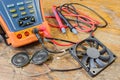 CCTV tester with probes, CPU fan and loudspeakers on a table in a workshop