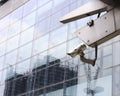 CCTV white camera on front of glass building Royalty Free Stock Photo