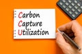 CCU Carbon capture utilization symbol. Concept words CCU Carbon capture utilization on beautiful note. Beautiful orange background Royalty Free Stock Photo