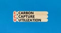 CCU Carbon capture utilization symbol. Concept words CCU Carbon capture utilization on beautiful stick. Beautiful blue background
