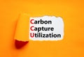 CCU Carbon capture utilization symbol. Concept words CCU Carbon capture utilization on beautiful paper. Beautiful orange