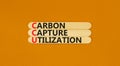 CCU Carbon capture utilization symbol. Concept words CCU Carbon capture utilization on beautiful stick. Beautiful orange